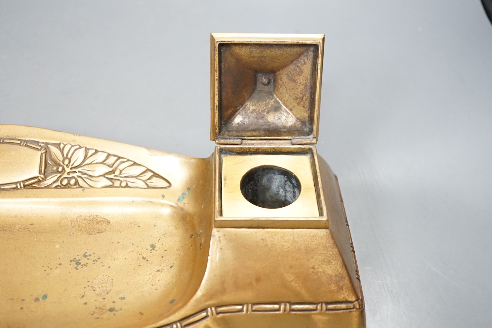 An Arts & Crafts style brass desk stand - 40cm wide